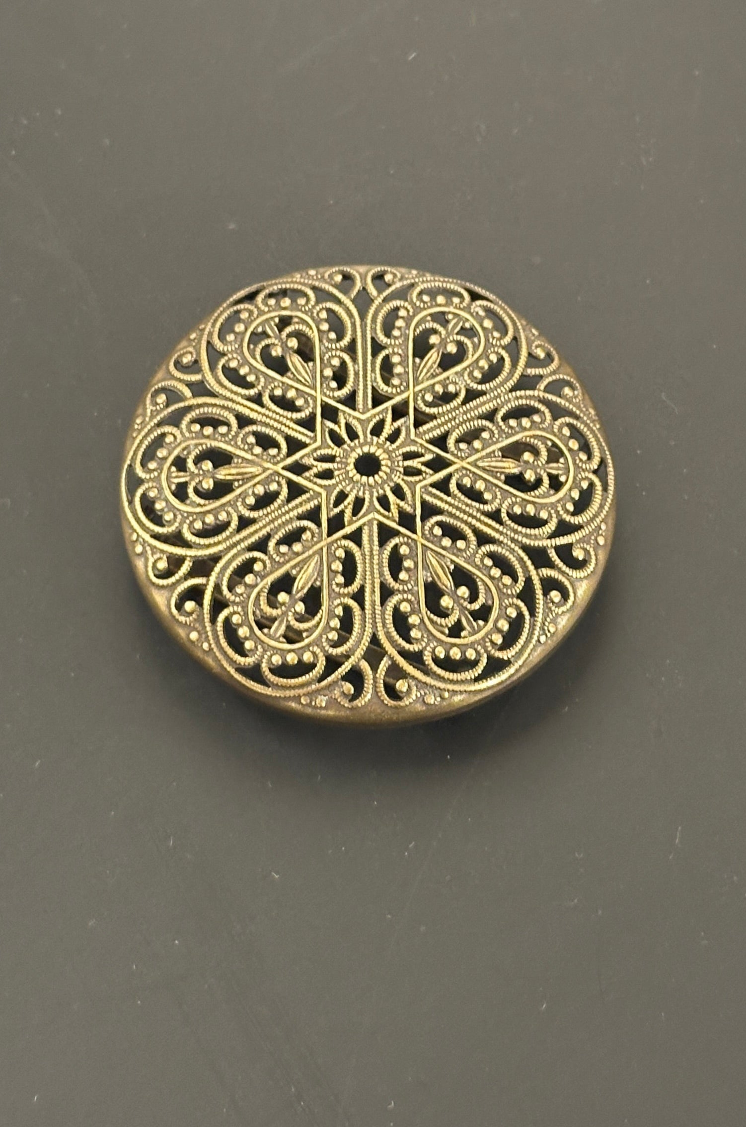 Schürzenspange rund altgold